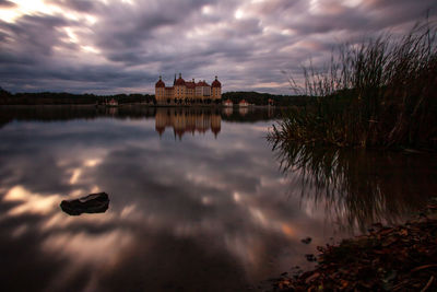 Reflection of clouds in water at sunset