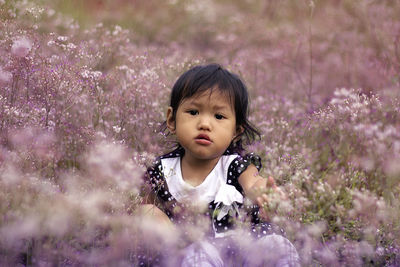 Portrait of a little girl amid flowers