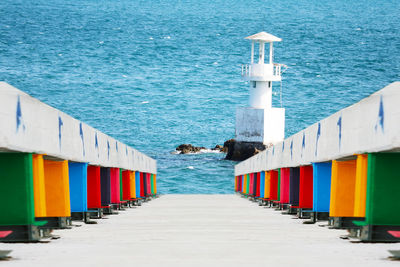 Beach huts by sea against buildings