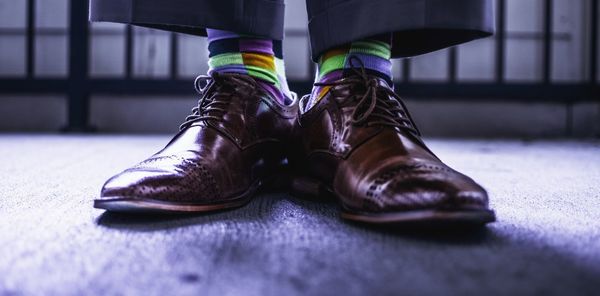 Low section of man wearing brown shoes on floor