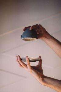 Close-up of hand holding coffee cup upside down