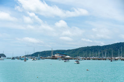 Sailboats in sea against sky