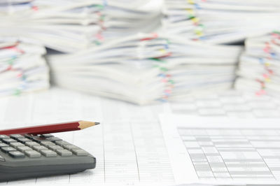 High angle view of pencil and calculator on financial documents