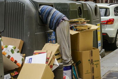 Man with cardboard waste on roadside