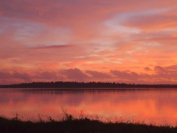 Scenic view of lake against romantic sky at sunset