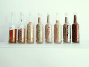 Full frame of bottles on white background
