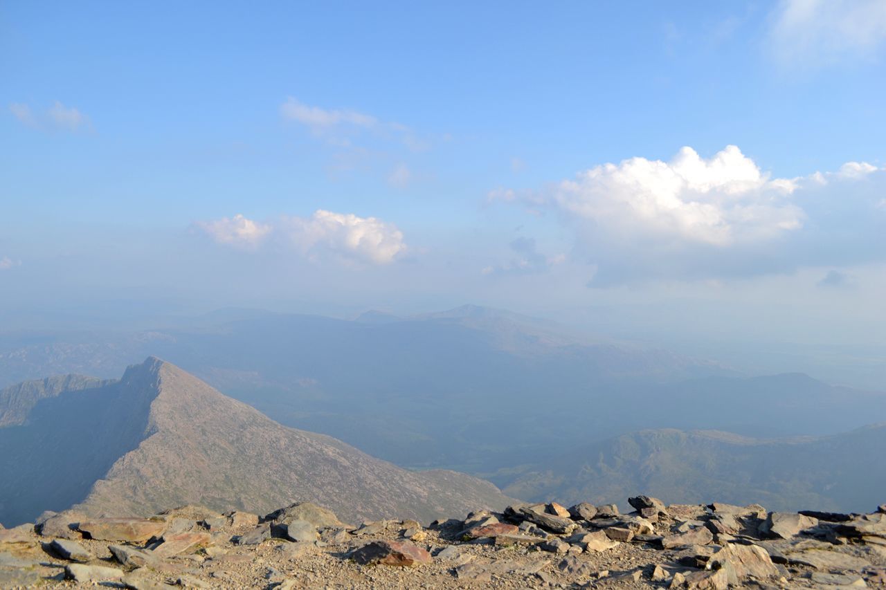 mountain, tranquil scene, tranquility, scenics, sky, landscape, beauty in nature, mountain range, nature, non-urban scene, cloud - sky, physical geography, idyllic, remote, geology, cloud, blue, day, outdoors, rock - object