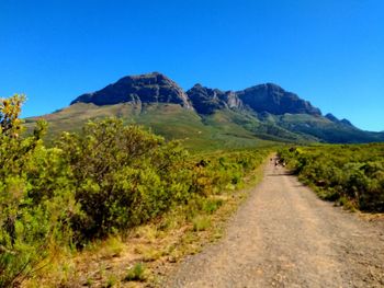 Scenic view of mountains against clear blue sky