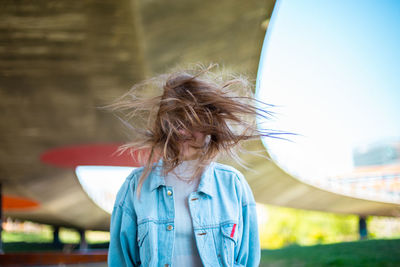 Woman tossing hair while standing outdoors