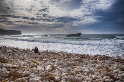 Man looking at sea against sky