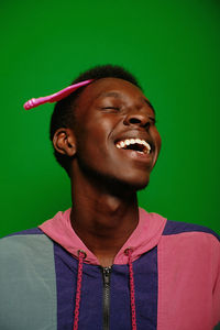 Low angle view of young man against blue background