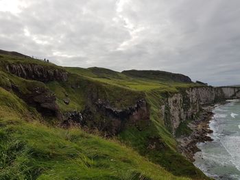 Scenic view of sea and mountains against sky