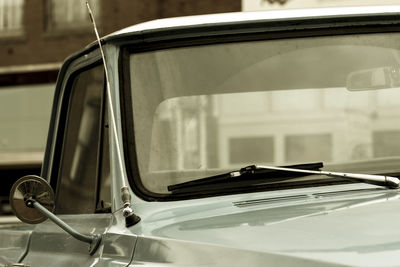 Close-up of vintage car in city