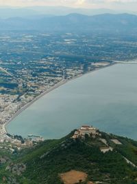 High angle view of townscape by sea against sky