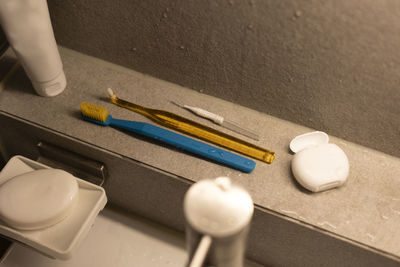 Various toothbrushes with dental floss in the bathroom