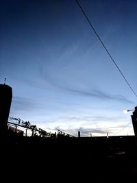 Low angle view of silhouette bridge against sky during sunset