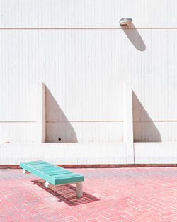 Umbrella on wall by swimming pool against building