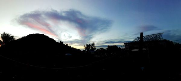 Silhouette of trees against sky at dusk