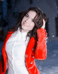 Portrait of young woman standing outdoors during winter