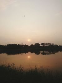 Scenic view of lake against sky during sunset