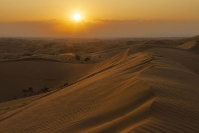 Scenic view of desert against sky during sunset