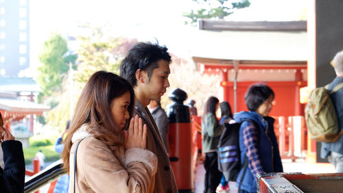 Young women pray  at japan temple