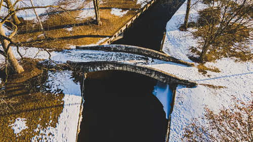 The early morning dawn colors lighting up a park footbridge in winter 