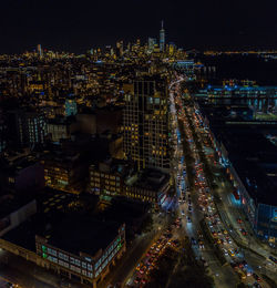 High angle view of city lit up at night