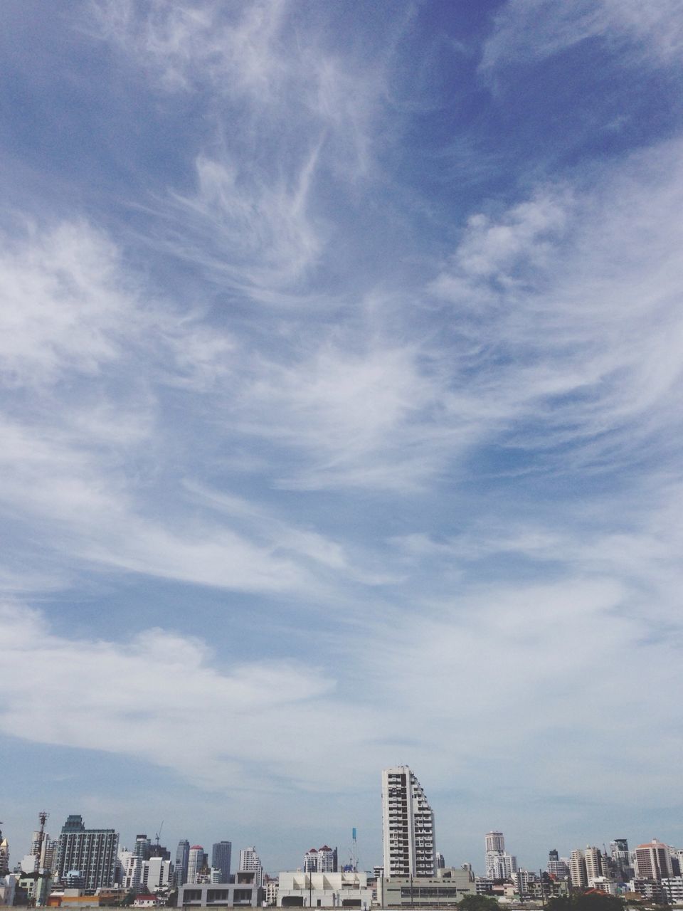 building exterior, architecture, built structure, city, sky, cloud - sky, cityscape, skyscraper, city life, cloud, cloudy, day, modern, building, residential building, outdoors, tall - high, office building, tower, urban skyline