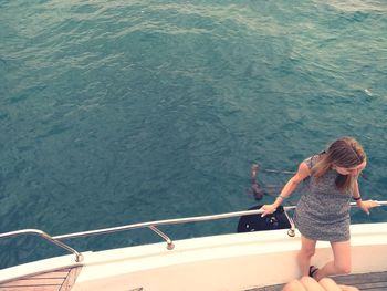 High angle view of woman standing on boat deck