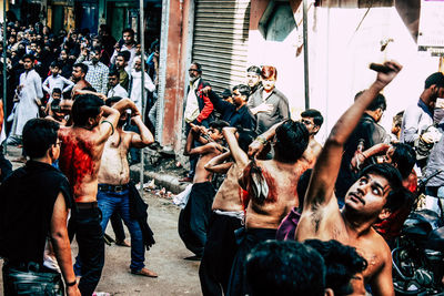 Group of people on street against buildings