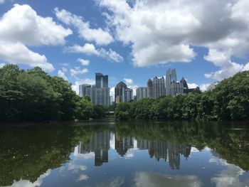 Reflection of buildings in lake against sky