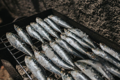 High angle view of fish on barbecue grill