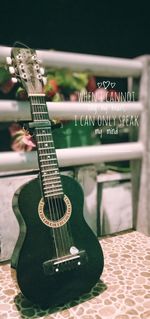 Close-up of guitar on table