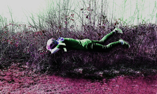 Side view of boy lying down on land