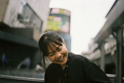 Smiling teenage girl by window