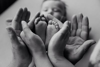 Close-up of hands holding feet of baby