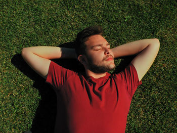 High angle view of teenage boy lying on grass