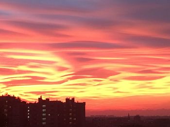 Silhouette buildings against sky during sunset