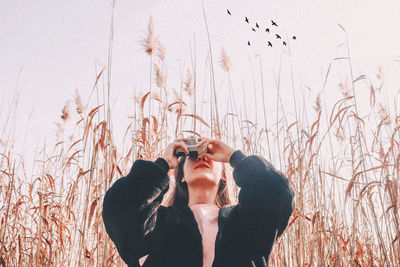 Low section of woman standing on field