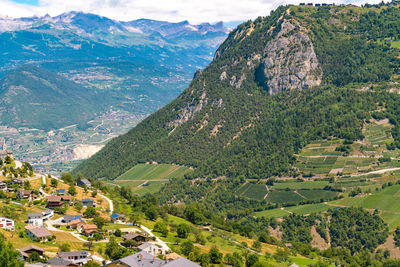 View of village in alps in summer with green mountains