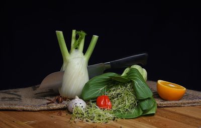 Close-up of vegetables on table against black background