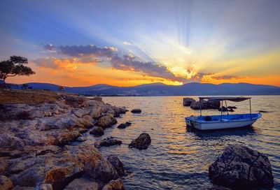 Scenic view of bay against sky during sunset