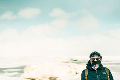 Portrait of man standing against sky