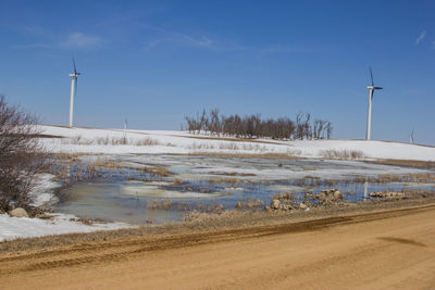 Scenic view of snow covered land against blue sky