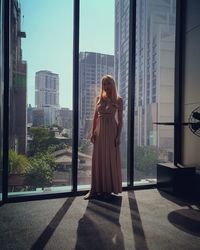 Woman standing by window