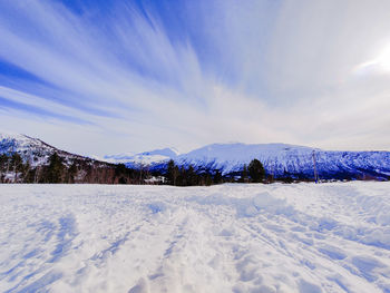 Scenic view of snow covered landscape against sky