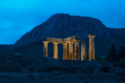 Ruins of building against mountain range