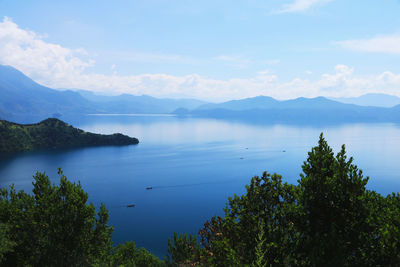 Scenic view of sea and mountains against sky