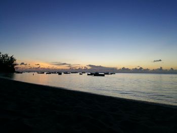 Scenic view of sea against clear sky during sunset